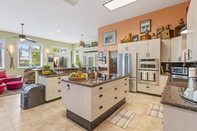 a kitchen with stainless steel appliances granite countertop a stove and a refrigerator