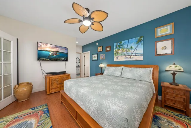 a bedroom with a bed and a flat screen tv