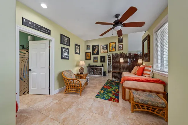 a living room with furniture and a ceiling fan