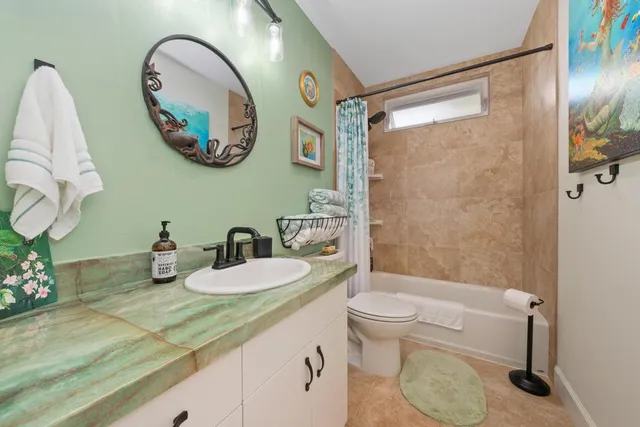 a bathroom with a toilet a sink and a mirror