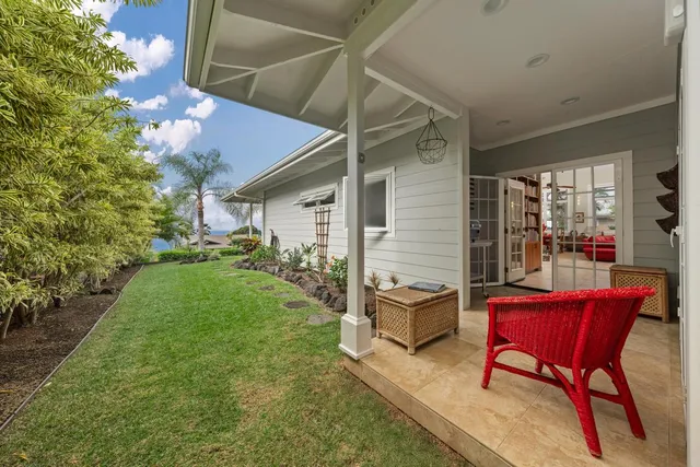 a view of a house with backyard and sitting area