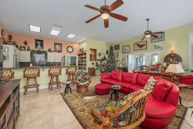 a living room with furniture a rug and a chandelier