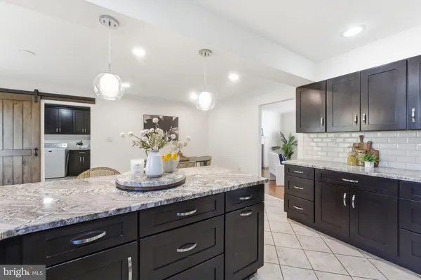 a spacious bathroom with a granite countertop sink toilet and shower