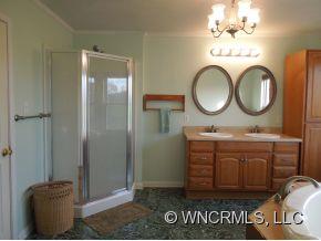 140 Hall Road Rutherfordton, NC 28139 - Photo 11 of 24 a bathroom with a sink a mirror and a shower