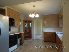 140 Hall Road Rutherfordton, NC 28139 - Photo 7 of 24 a kitchen with kitchen island a counter top space cabinets and stainless steel appliances