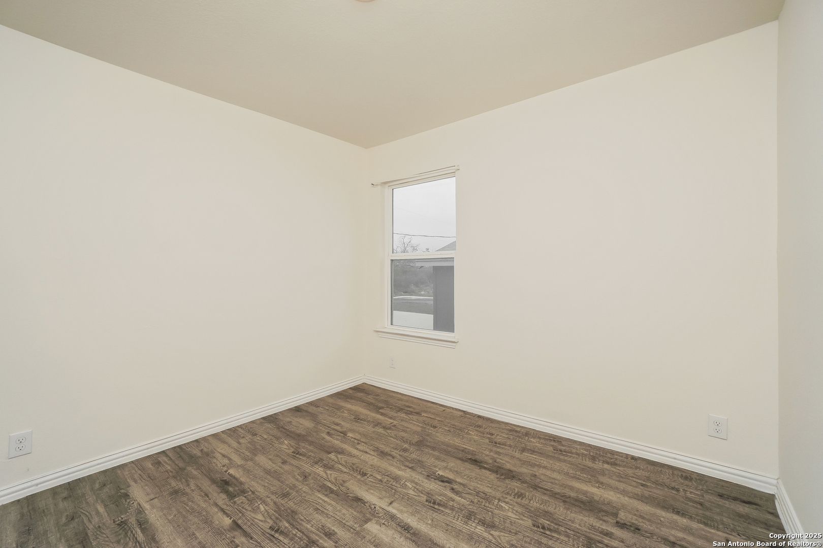 5334 Natho Street San Antonio, TX 78222 - Photo 13 of 21 an empty room with wooden floor and windows