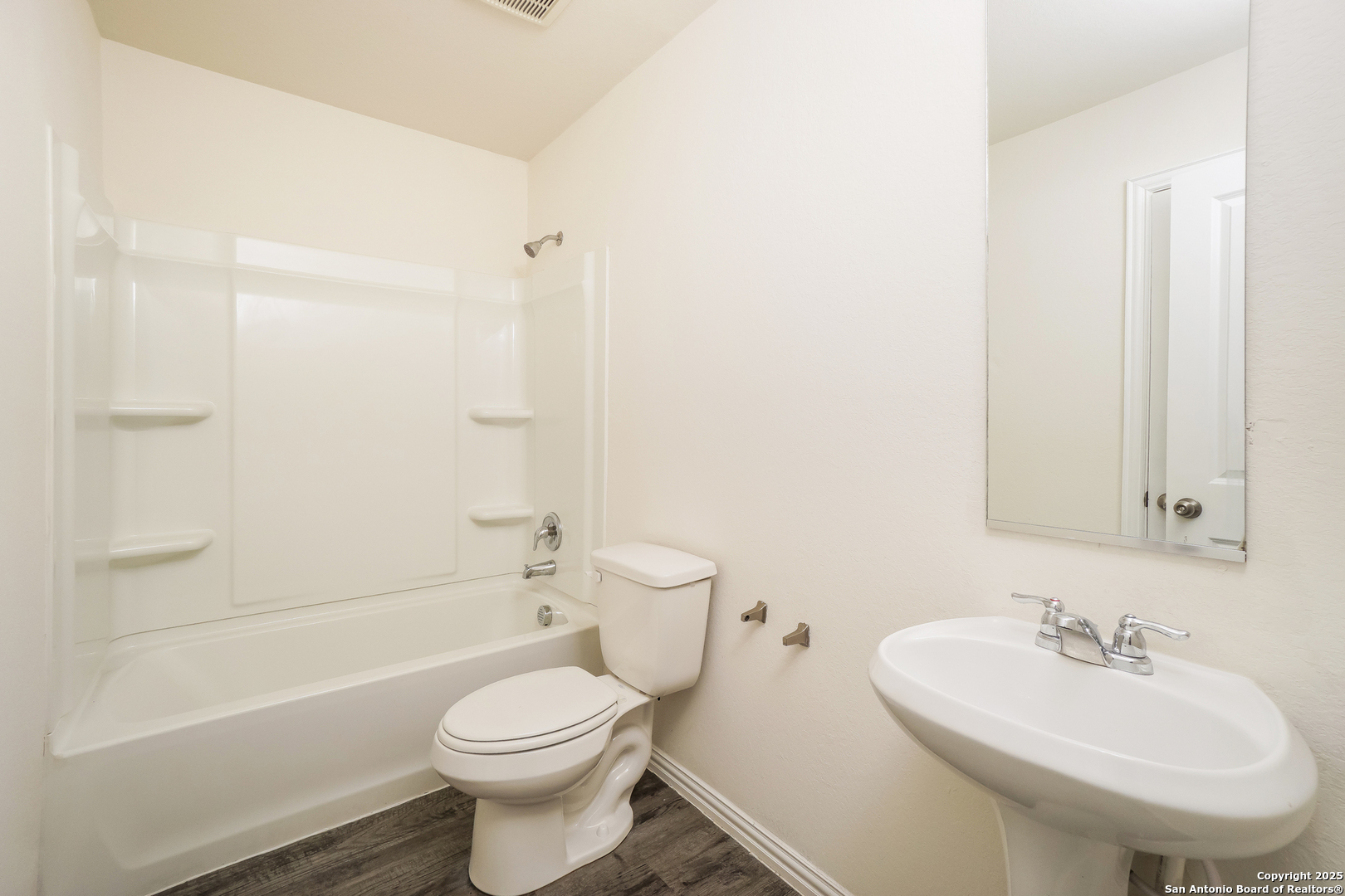 5334 Natho Street San Antonio, TX 78222 - Photo 17 of 21 a bathroom with a toilet sink and mirror