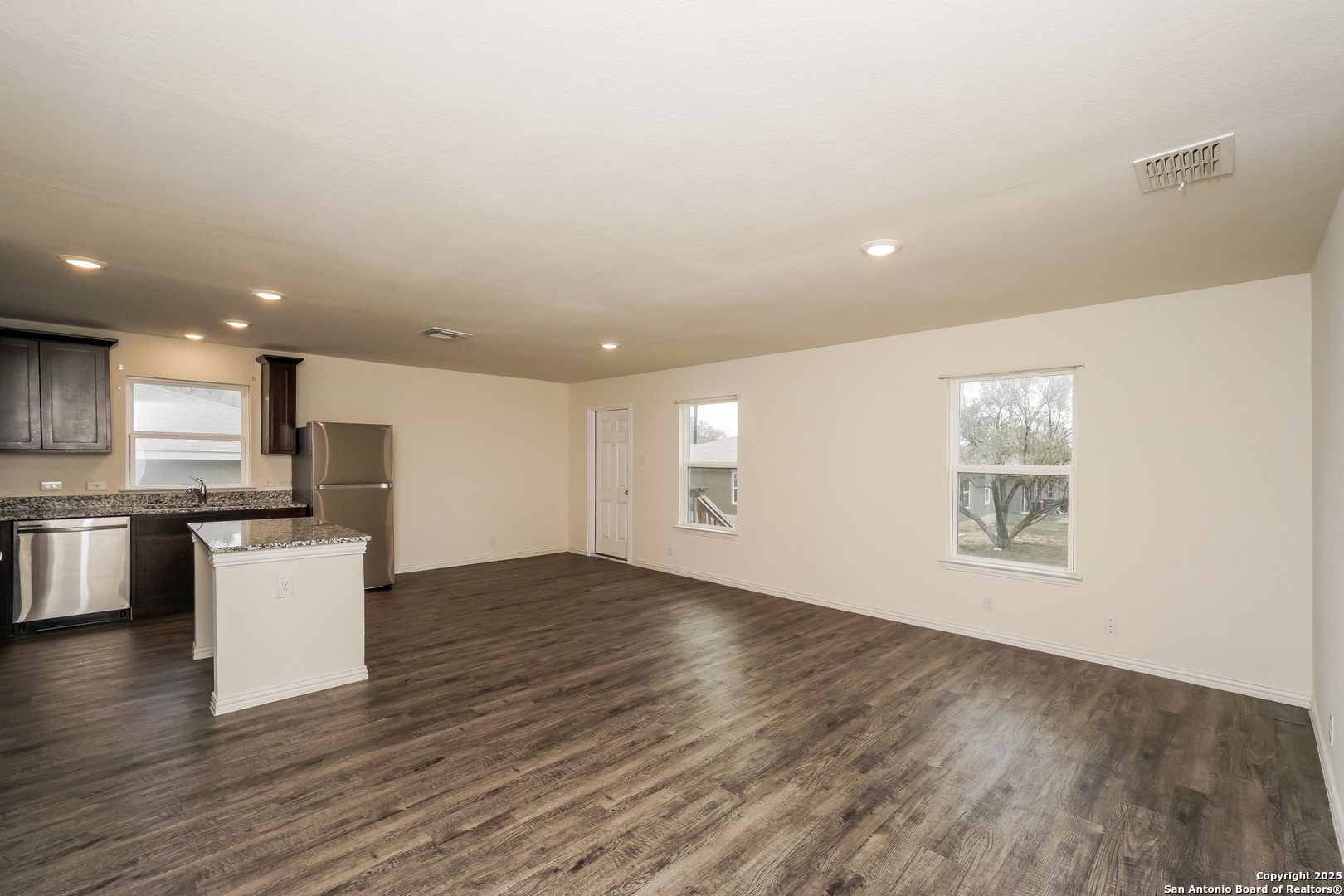 5334 Natho Street San Antonio, TX 78222 - Photo 4 of 21 a view of an empty room with wooden floor and a window