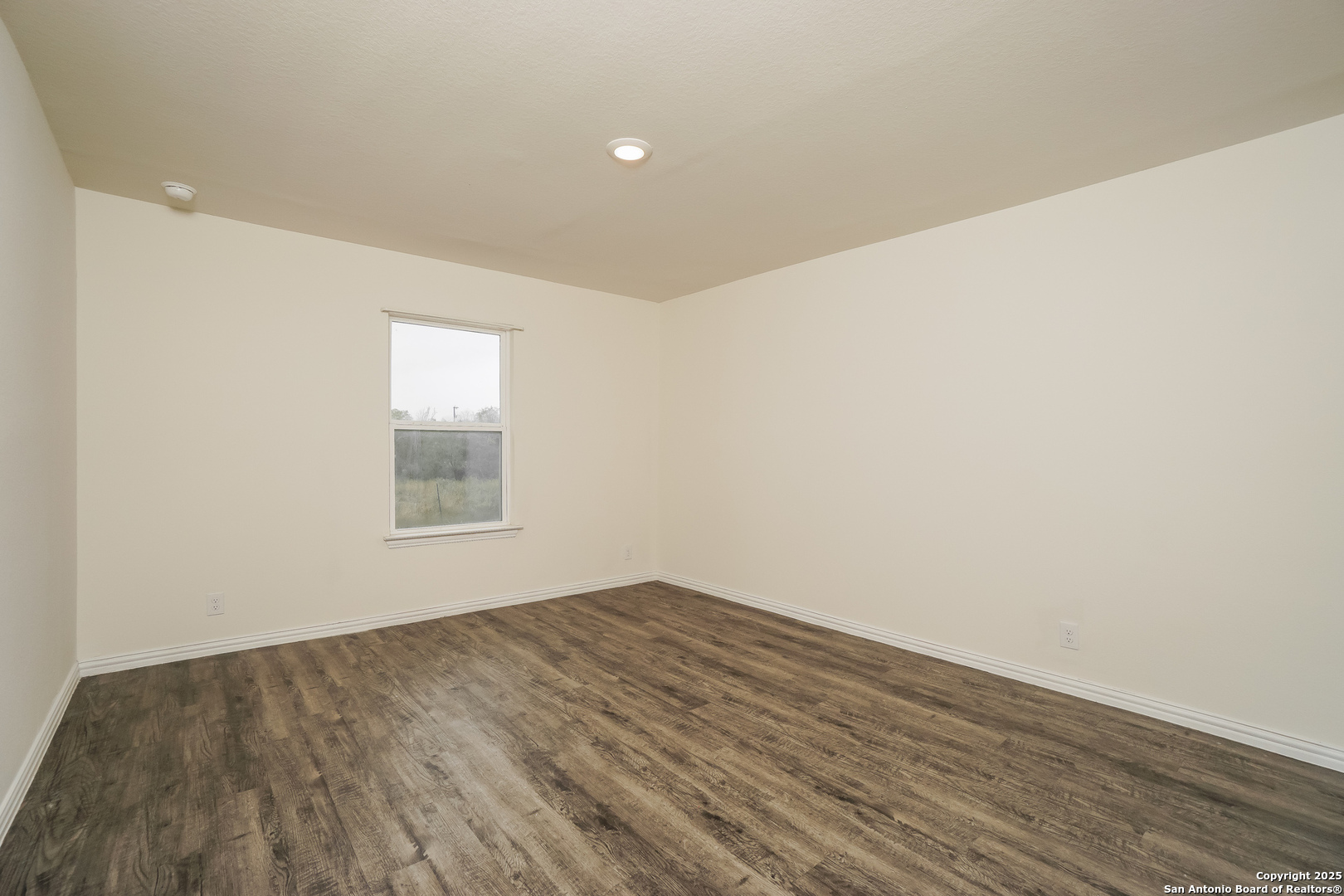 5334 Natho Street San Antonio, TX 78222 - Photo 8 of 21 an empty room with wooden floor and windows