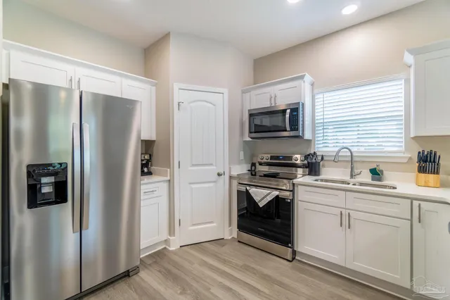 a kitchen with stainless steel appliances a refrigerator stove and sink