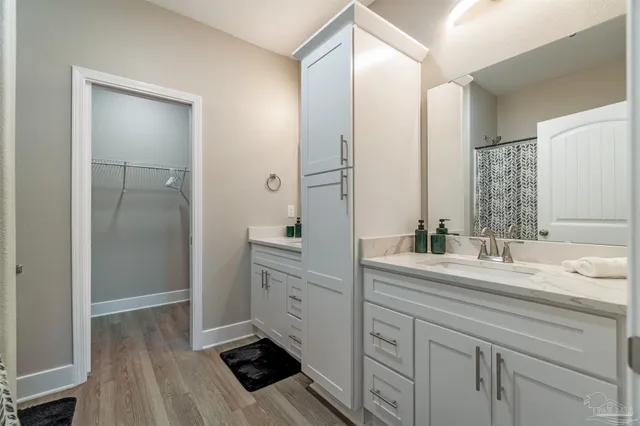 a spacious bathroom with a double vanity sink mirror and shower