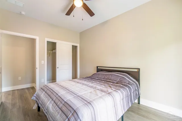 a bedroom with a bed and wooden floor