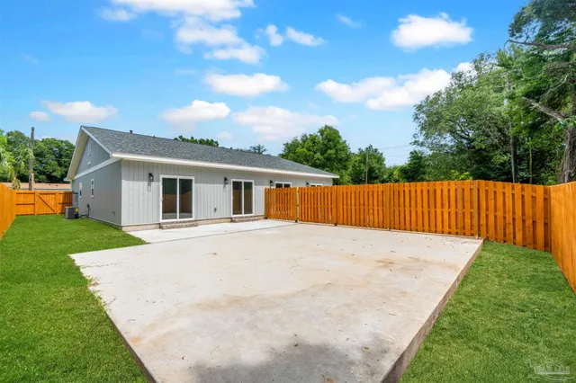 a backyard of a house with plants and a garden