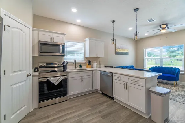 a kitchen with a sink stove and microwave