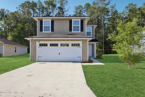 a view of a house with a yard