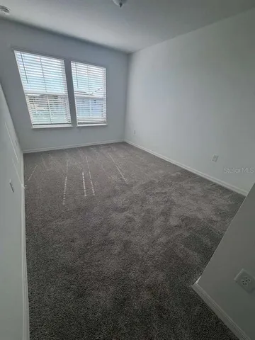 a spacious bathroom with a granite countertop sink a toilet and bathtub