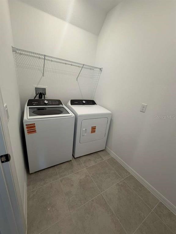 4617 Orchard View Alley Winter Garden, FL 34787 - Photo 26 of 32 a utility room with dryer and washer