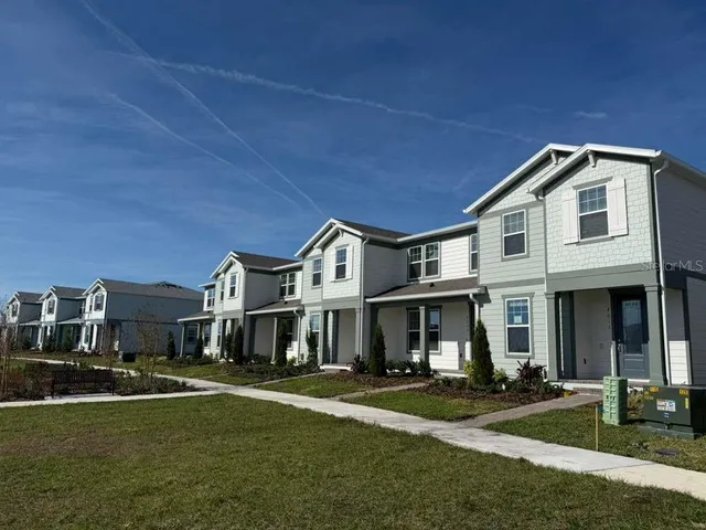 a front view of a residential apartment building with a yard