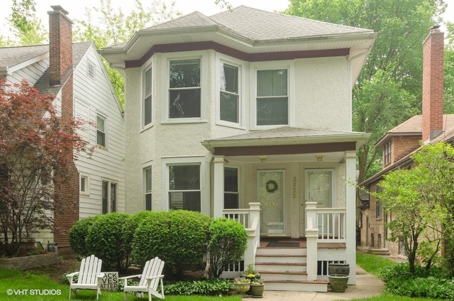2022 Colfax Street, Unit 1 Evanston, IL 60201 - Photo 1 of 10 a view of a brick house with plants and large tree