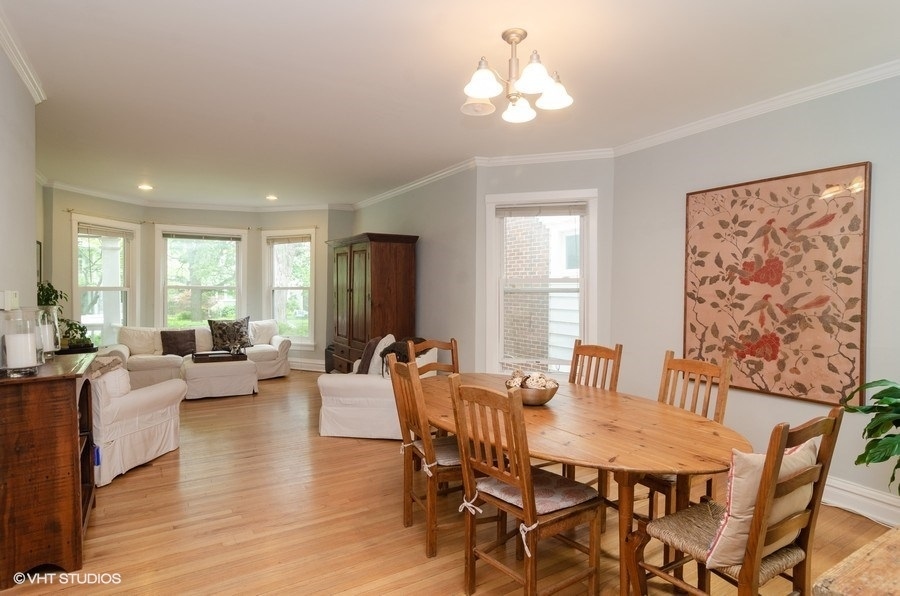 2022 Colfax Street, Unit 1 Evanston, IL 60201 - Photo 4 of 10 a view of a dining room with furniture window and wooden floor