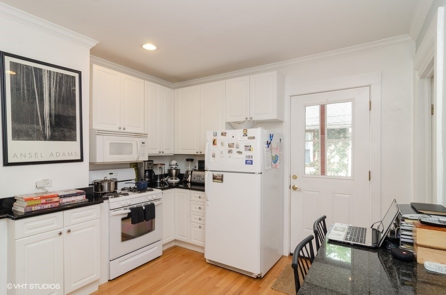 2022 Colfax Street, Unit 1 Evanston, IL 60201 - Photo 5 of 10 a kitchen with a refrigerator and white cabinets