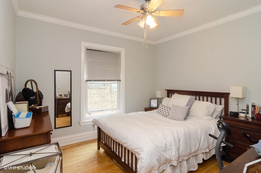 2022 Colfax Street, Unit 1 Evanston, IL 60201 - Photo 8 of 10 a bedroom with a bed and wooden floor
