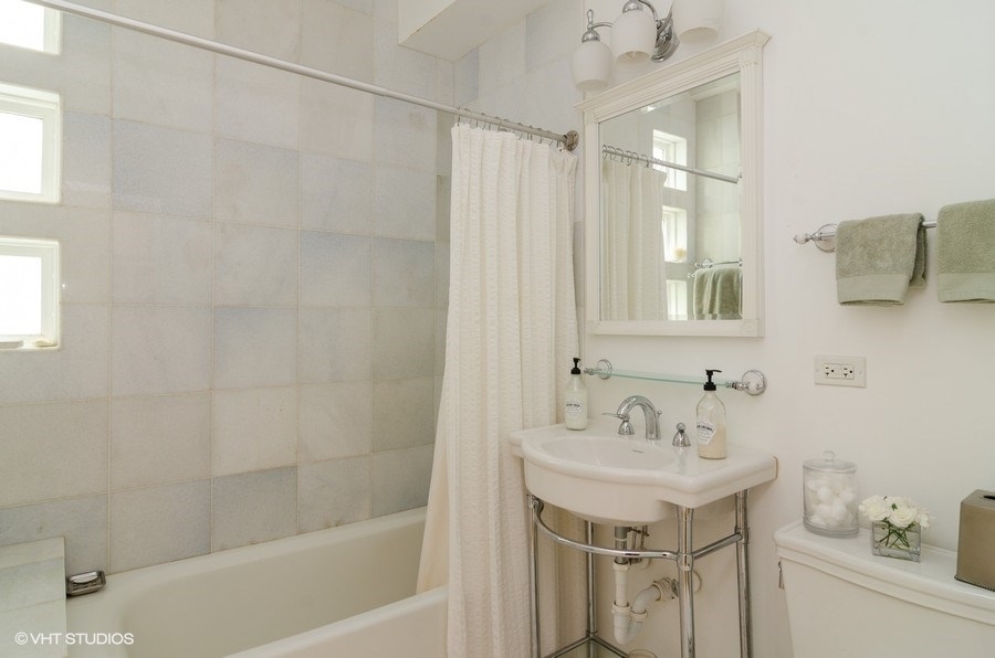 2022 Colfax Street, Unit 1 Evanston, IL 60201 - Photo 9 of 10 a bathroom with a sink toilet a mirror and shower
