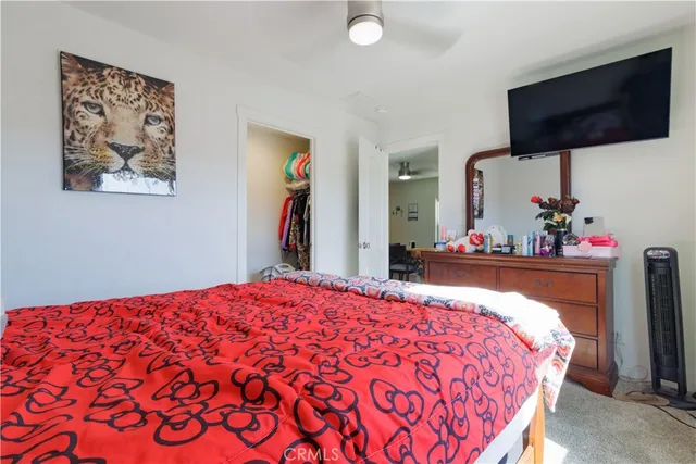 a bed room with a bed and a television