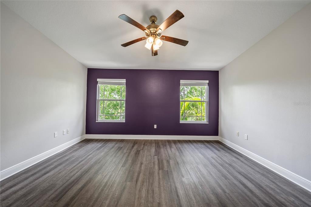 558 Harbor Ridge Drive Palm Harbor, FL 34683 - Photo 11 of 27 a view of room with window ceiling fan and hardwood floor