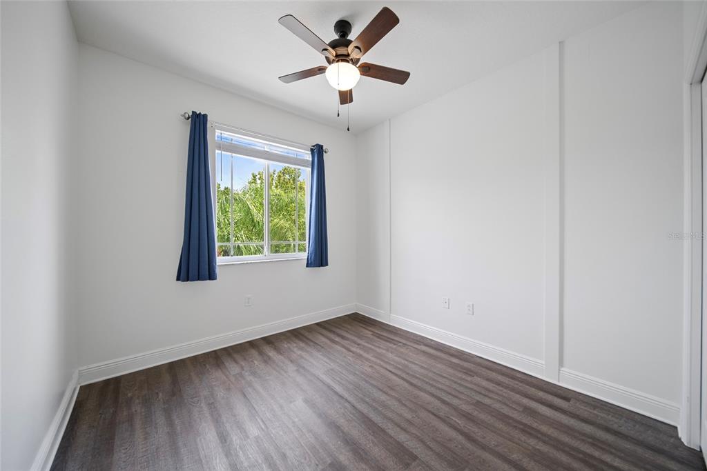 558 Harbor Ridge Drive Palm Harbor, FL 34683 - Photo 14 of 27 wooden floor in an empty room with a window