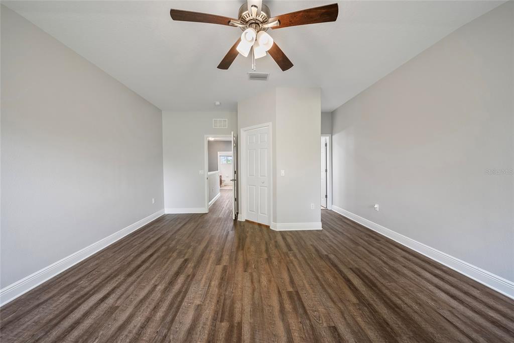 558 Harbor Ridge Drive Palm Harbor, FL 34683 - Photo 16 of 27 a view of an empty room with wooden floor