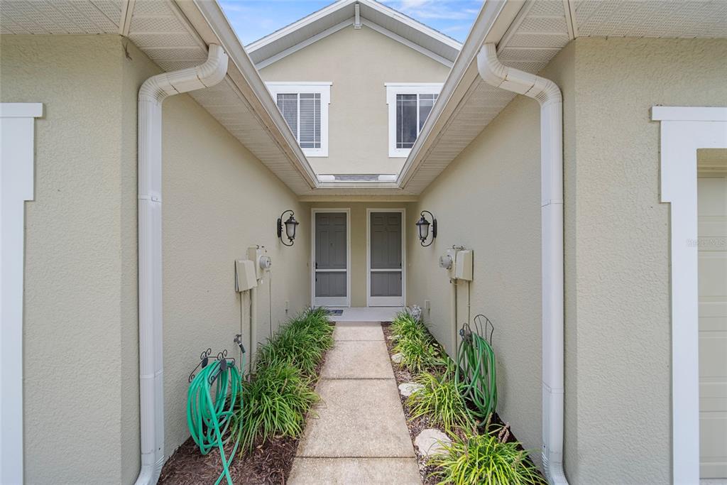 558 Harbor Ridge Drive Palm Harbor, FL 34683 - Photo 3 of 27 a view of a pathway with house on both side
