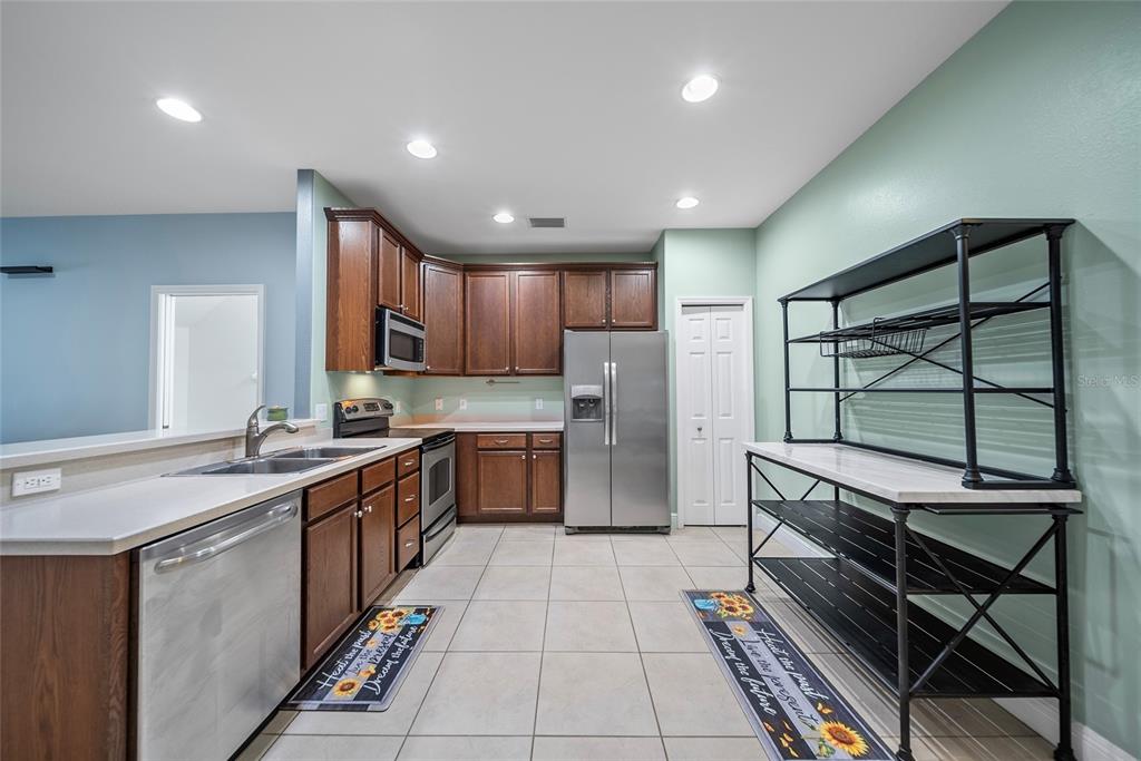 558 Harbor Ridge Drive Palm Harbor, FL 34683 - Photo 5 of 27 a kitchen with stainless steel appliances granite countertop a sink counter space cabinets and a large window