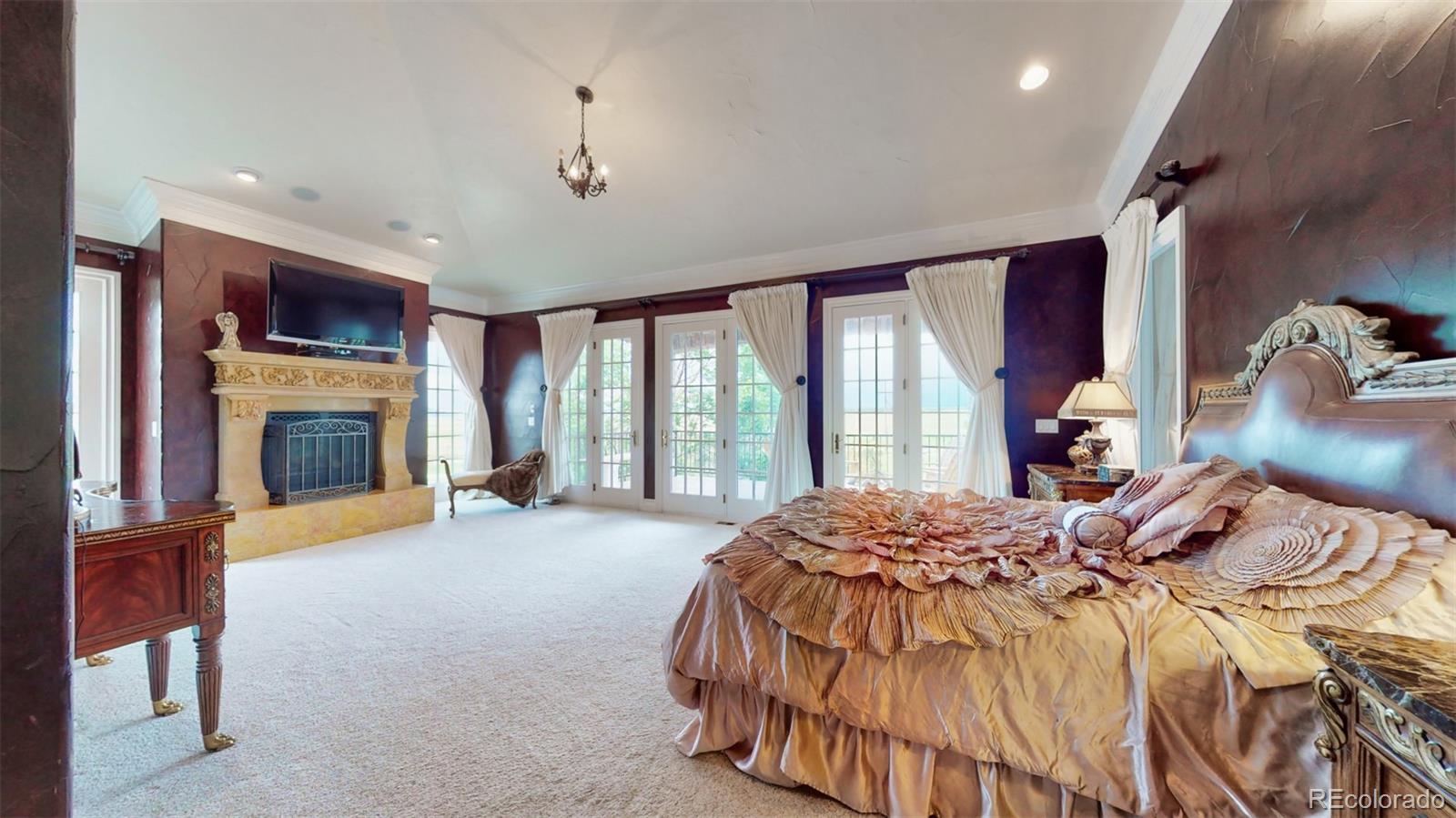 2775 E Highway Monument, CO 80132 - Photo 12 of 40 a bedroom with a bed and a fireplace