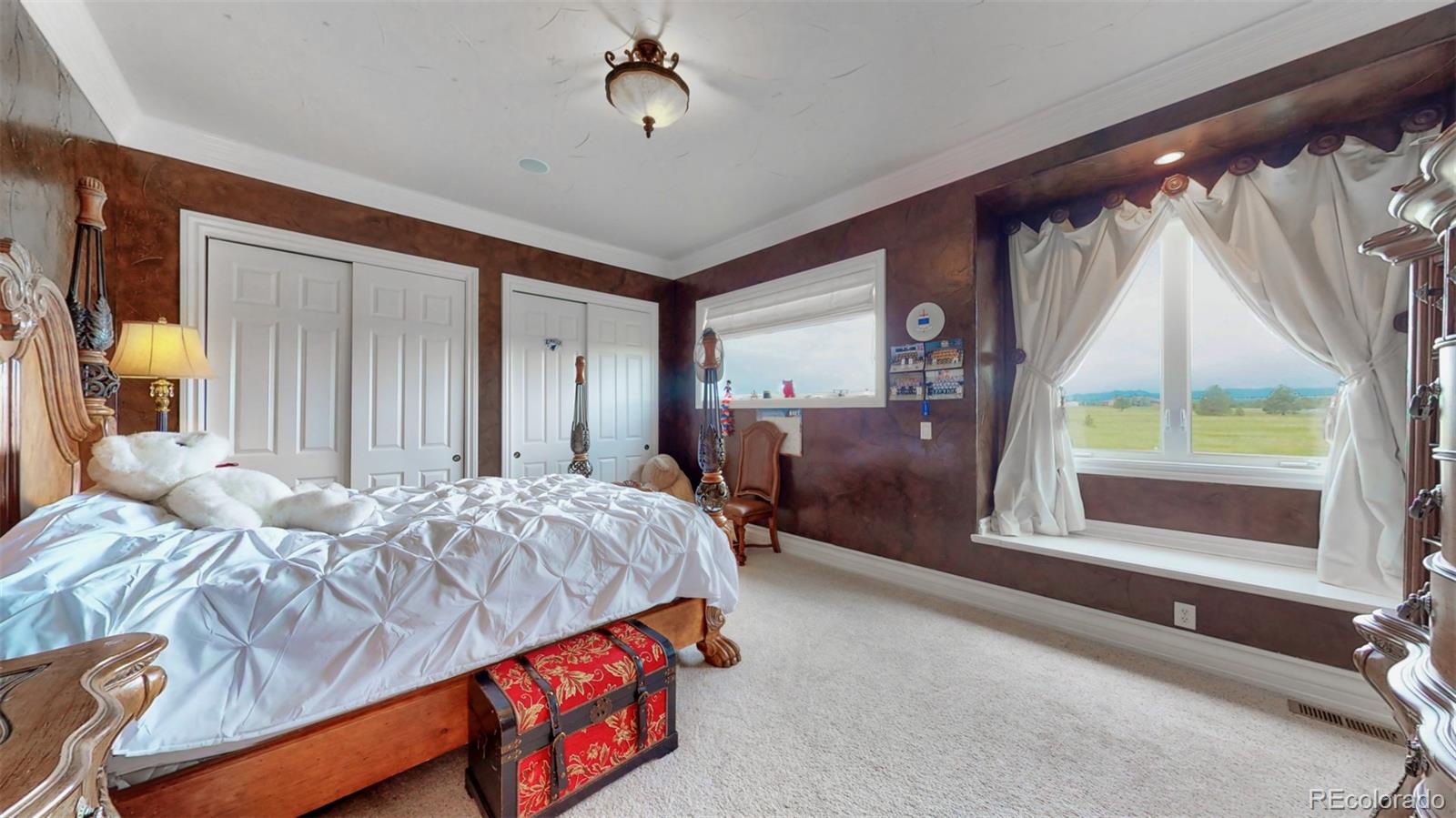 2775 E Highway Monument, CO 80132 - Photo 16 of 40 a bedroom with a bed and a mirror