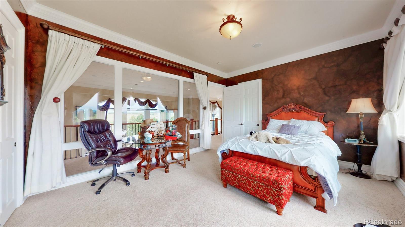 2775 E Highway Monument, CO 80132 - Photo 19 of 40 a bedroom with furniture and a chandelier