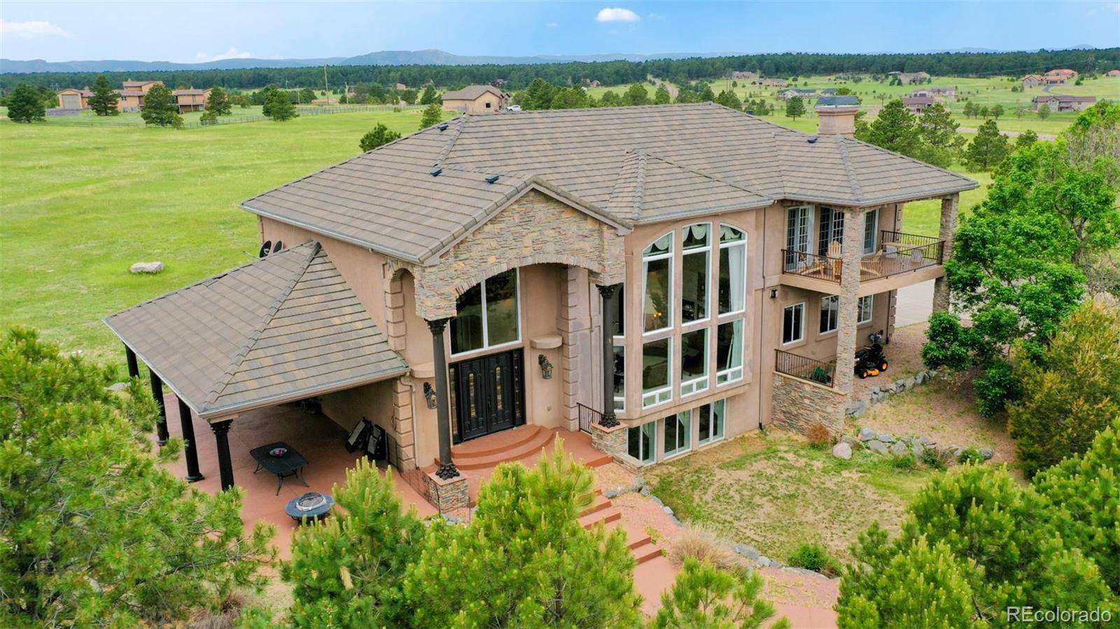 2775 E Highway Monument, CO 80132 - Photo 2 of 40 an aerial view of a house with a garden and yard