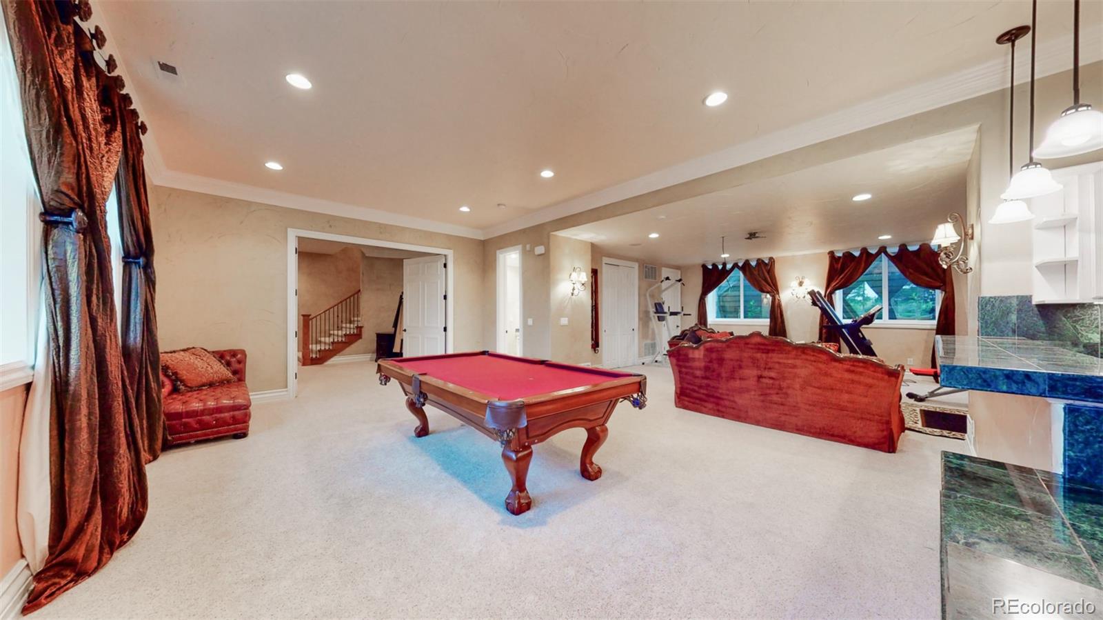 2775 E Highway Monument, CO 80132 - Photo 22 of 40 a living room with furniture pool table and a flat screen tv