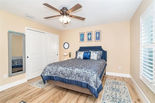 a bedroom with a large bed and a chandelier