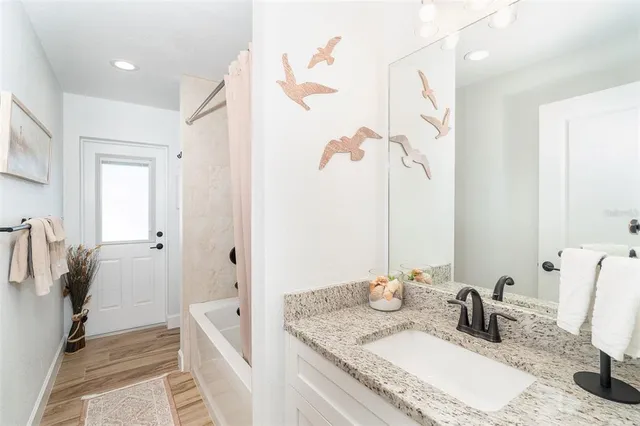 a bathroom with double vanity sinks and a mirror