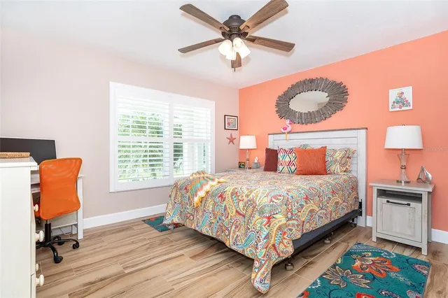 a bedroom with a bed a dresser and chair