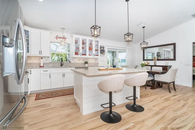 a kitchen with a sink a counter space appliances and cabinets