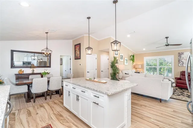 a view of living room with granite countertop furniture and wooden floor