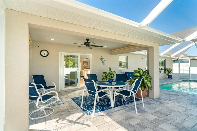 a view of a dining room with furniture and chandelier