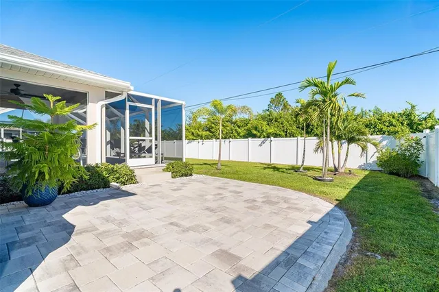 a view of a house with a yard and potted plants