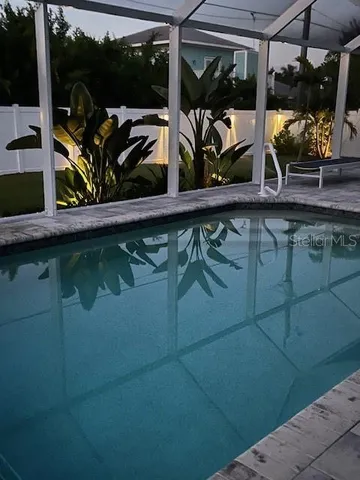 a view of hallway with sink and mirror