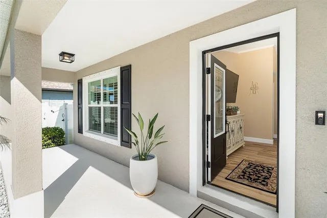a view of a hallway with wooden floor and a glass door