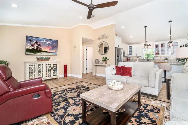 a living room with furniture and wooden floor