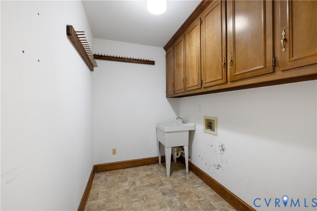 8939 Cardiff Road North Chesterfield, VA 23236 - Photo 14 of 45 Laundry room featuring cabinet space and stone fin