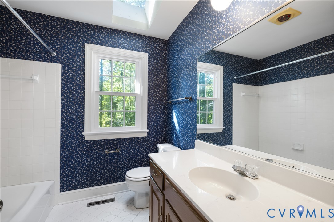 8939 Cardiff Road North Chesterfield, VA 23236 - Photo 19 of 45 Bathroom featuring vanity, a skylight, wallpapered